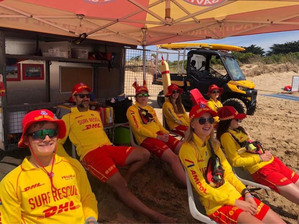 Lifeguards sitting under lifeguard tent